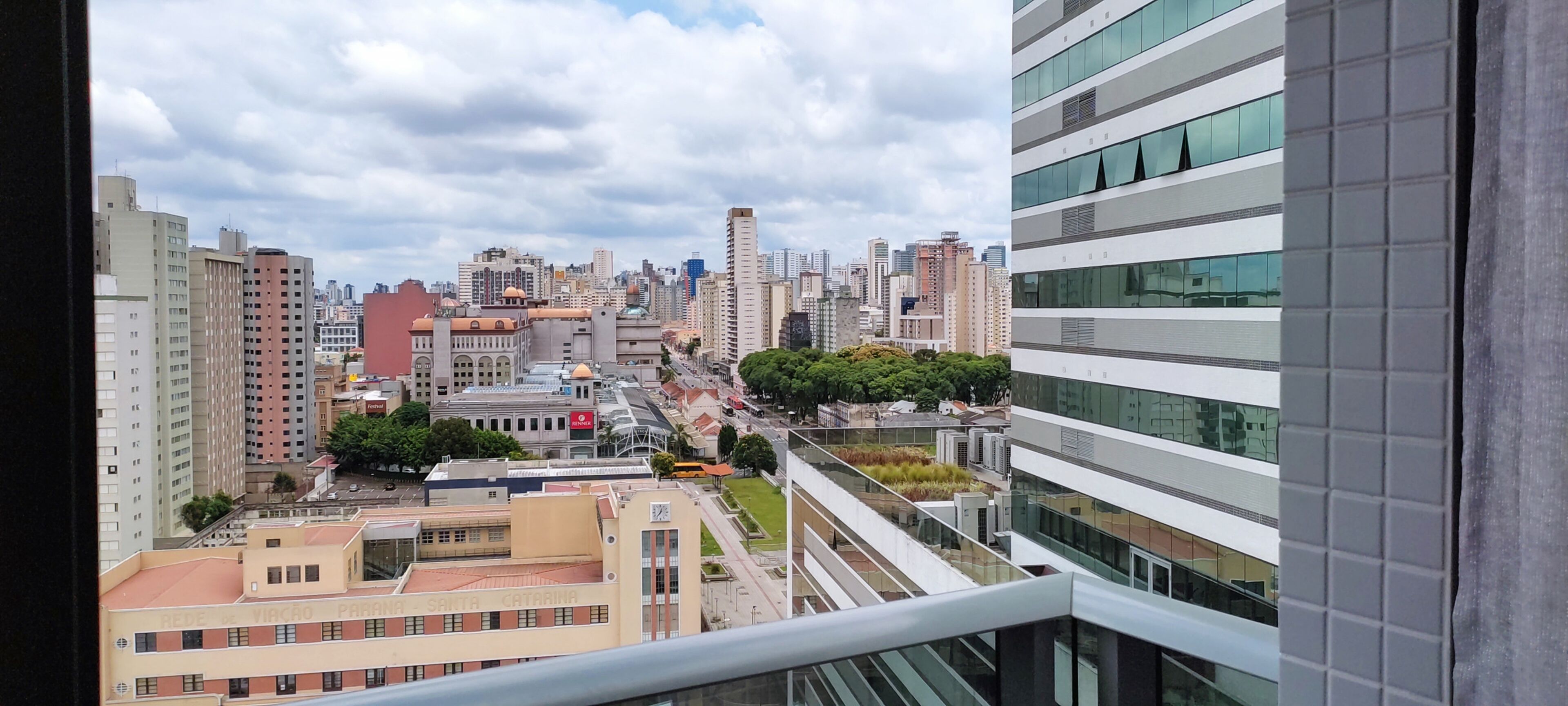 A high-rise building with a modern architectural design, featuring multiple floors and a glass facade.
