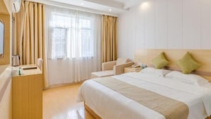 A hotel room with a large bed, a desk with a telephone, and a window with curtains. - GreenTree Inn HeFei South High-Speed Railway Station BaoHe Avenue Baohe District Government Hotel (Hefei)