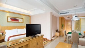 A hotel room with a bed, a television, a wooden cabinet, a coffee table, and a billiards table. - Vienna Hotel (Shenzhen Tianbao Road) (SHENZHEN)
