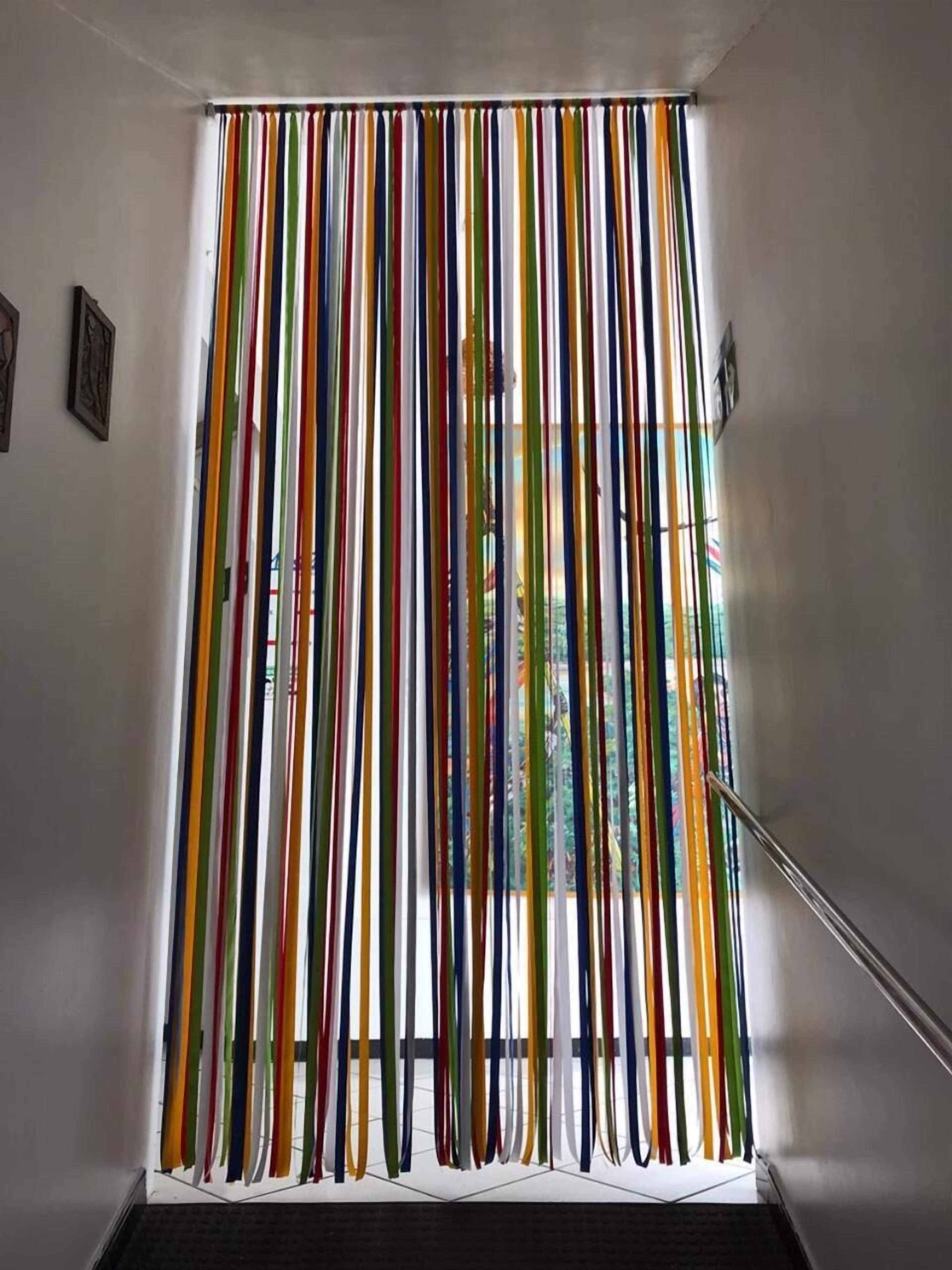 A staircase with a colorful curtain.