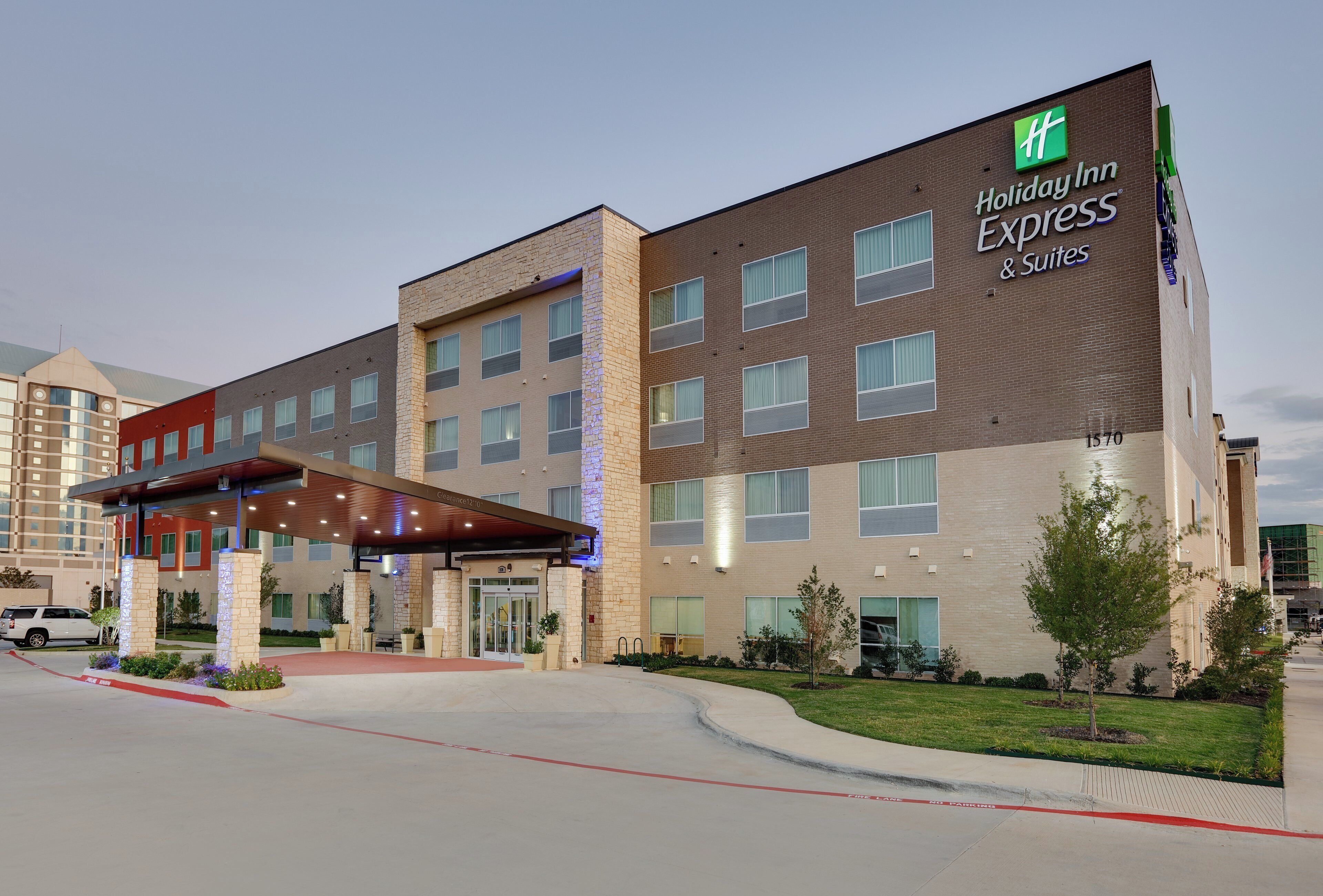 A Holiday Inn Express hotel with a covered entrance, multiple floors, and a brick facade.