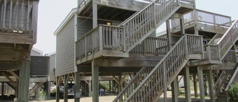 A multi-level wooden structure with outdoor staircases and railings.