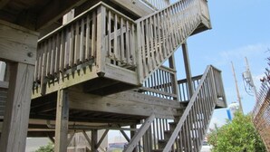 A multi-level wooden structure with railings and stairs.