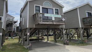 A wooden structure with a balcony and a sign reading "Foolish Endeavor".