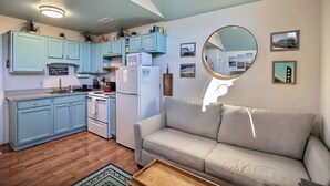 A compact living space with a kitchenette, a sofa, and a dining area. - 4 Carolina Lady Studio Bedroom Condo by RedAwning (Hatteras)