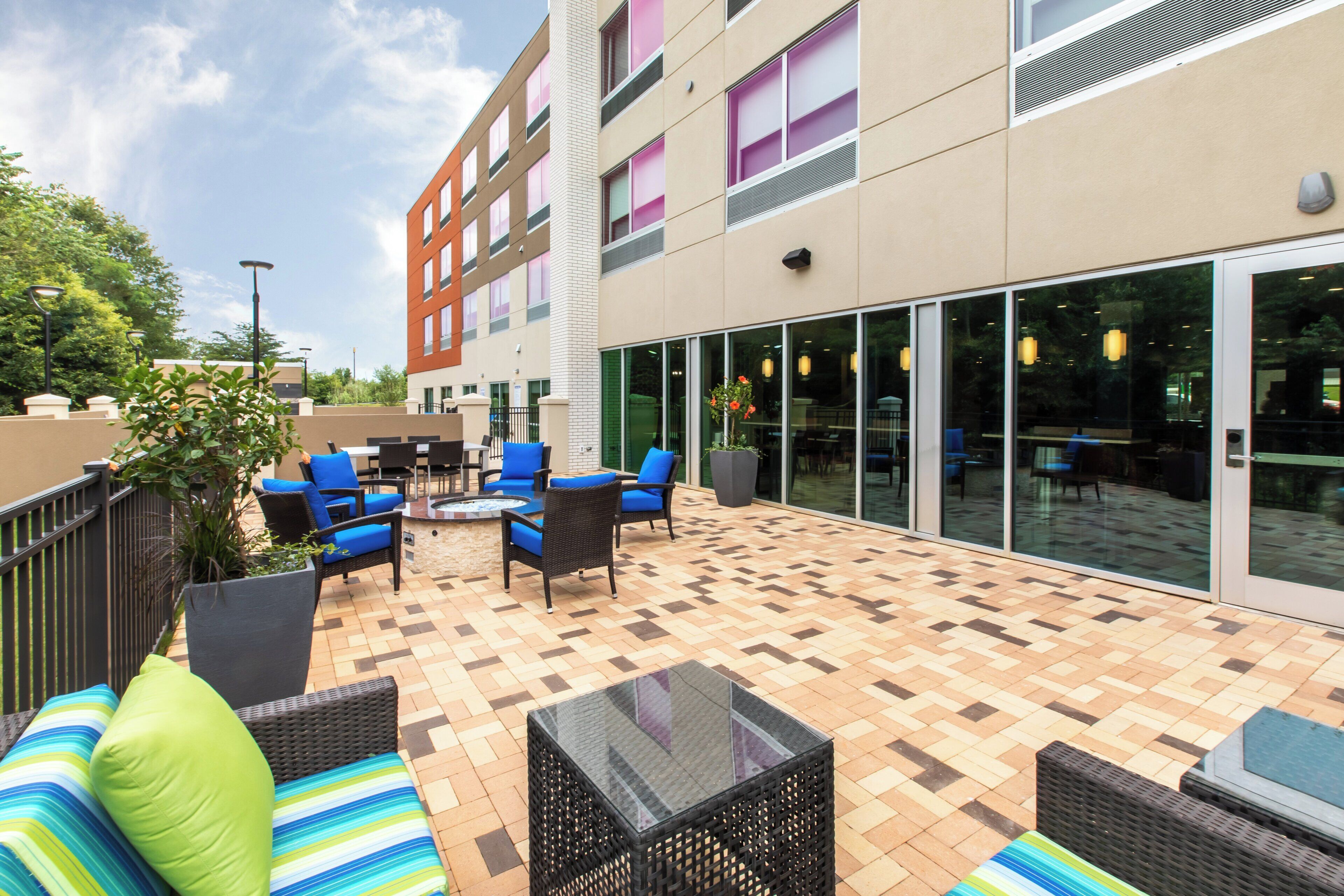 An outdoor patio area with seating and a fire pit.