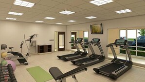 A fitness room with treadmills, a stationary bike, and a rowing machine. - Holiday Inn Express & Suites Greenville S- Piedmont by IHG (Piedmont)