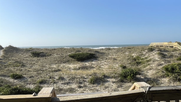 A beach view with dunes and a wooden fence. - Time / Tide 4 Bedroom Cottage by RedAwning (Hatteras)