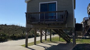 A two-story house with a balcony on the upper floor.