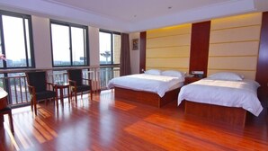 A hotel room with two beds, a balcony, and a view of the city. - GreenTree Inn ChangZhou East DongFang Road HengNai Logistics Park Express Hotel (Changzhou)