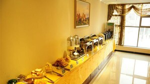 A buffet setup with various food items and a coffee station. - GreenTree Inn Fuyang Taihe County South Xiyang Road Hotel (Fuyang)