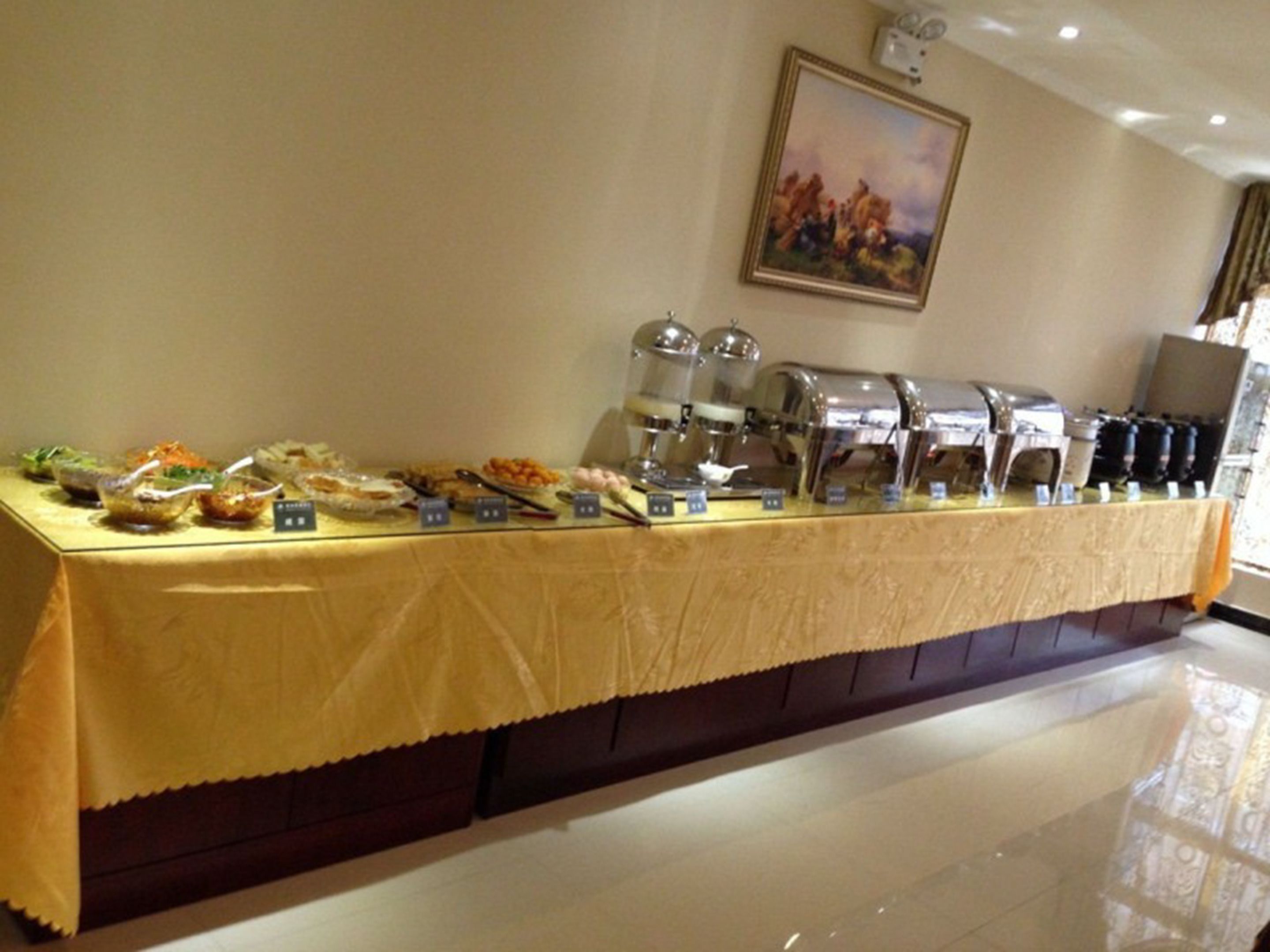 A buffet setup with various food items and a coffee station.