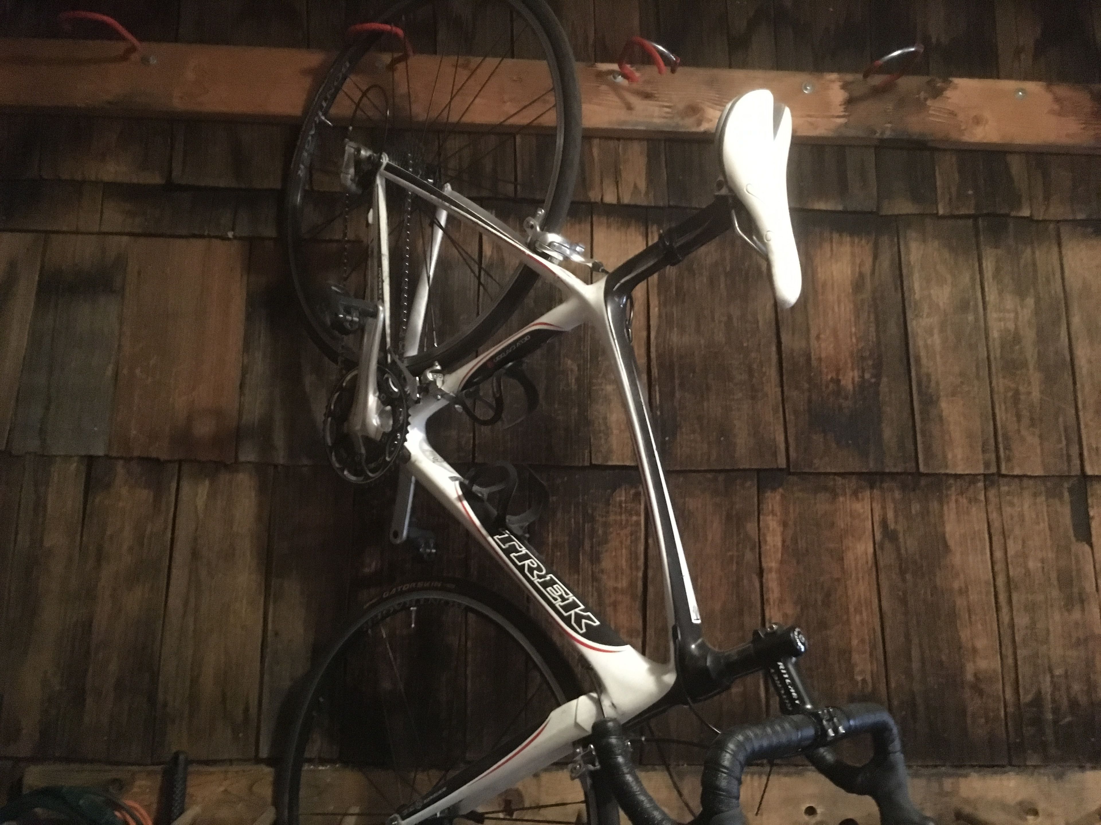 A bicycle leaning against a wooden wall.