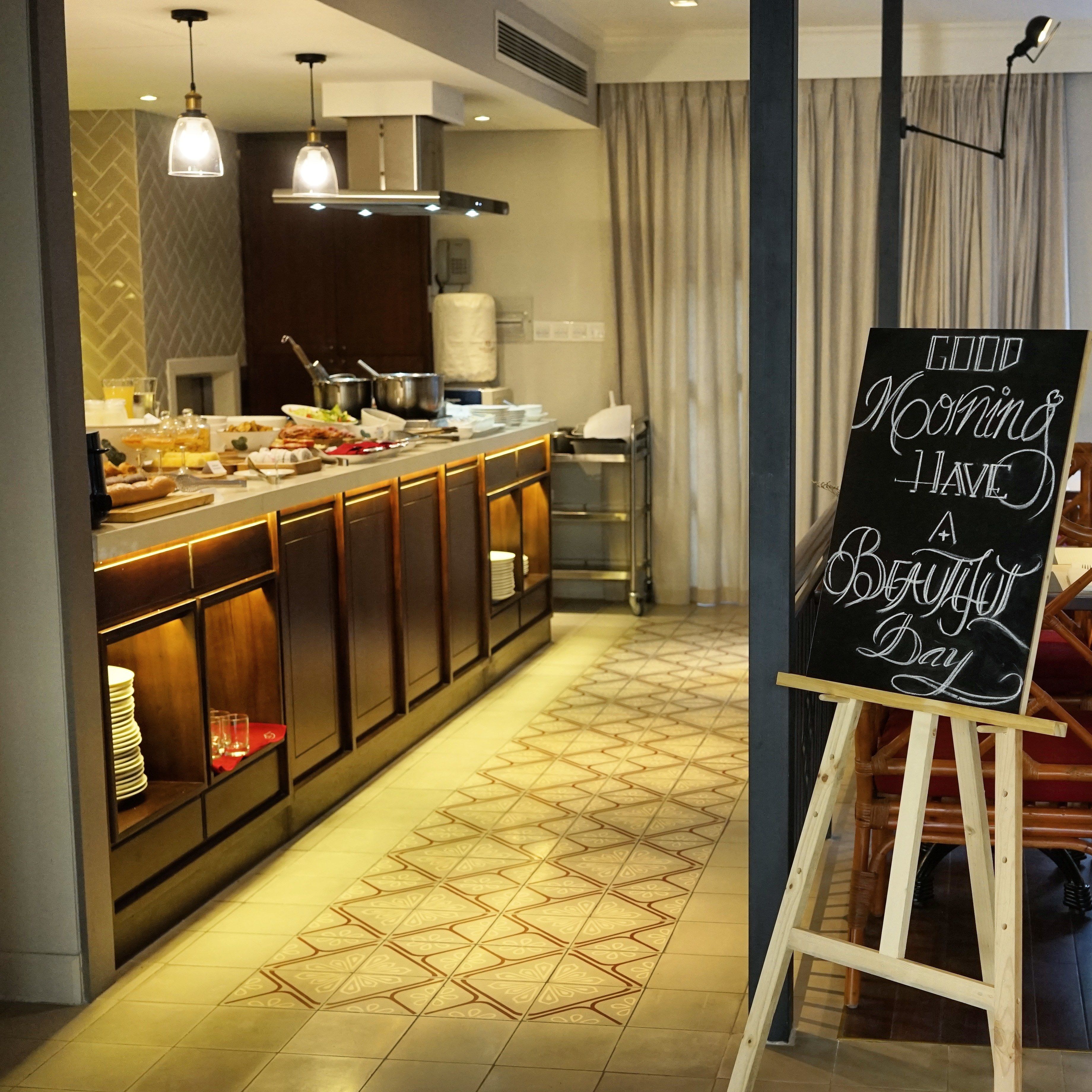 A breakfast bar with a chalkboard sign reading "GOOD MORNING HAVE A BEAUTIFUL DAY".