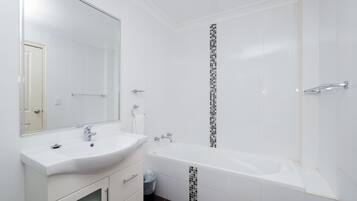 Separate bathtub and shower, towels