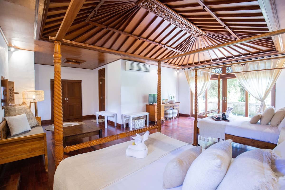 Una habitación con una cama con dosel, un escritorio y una silla.