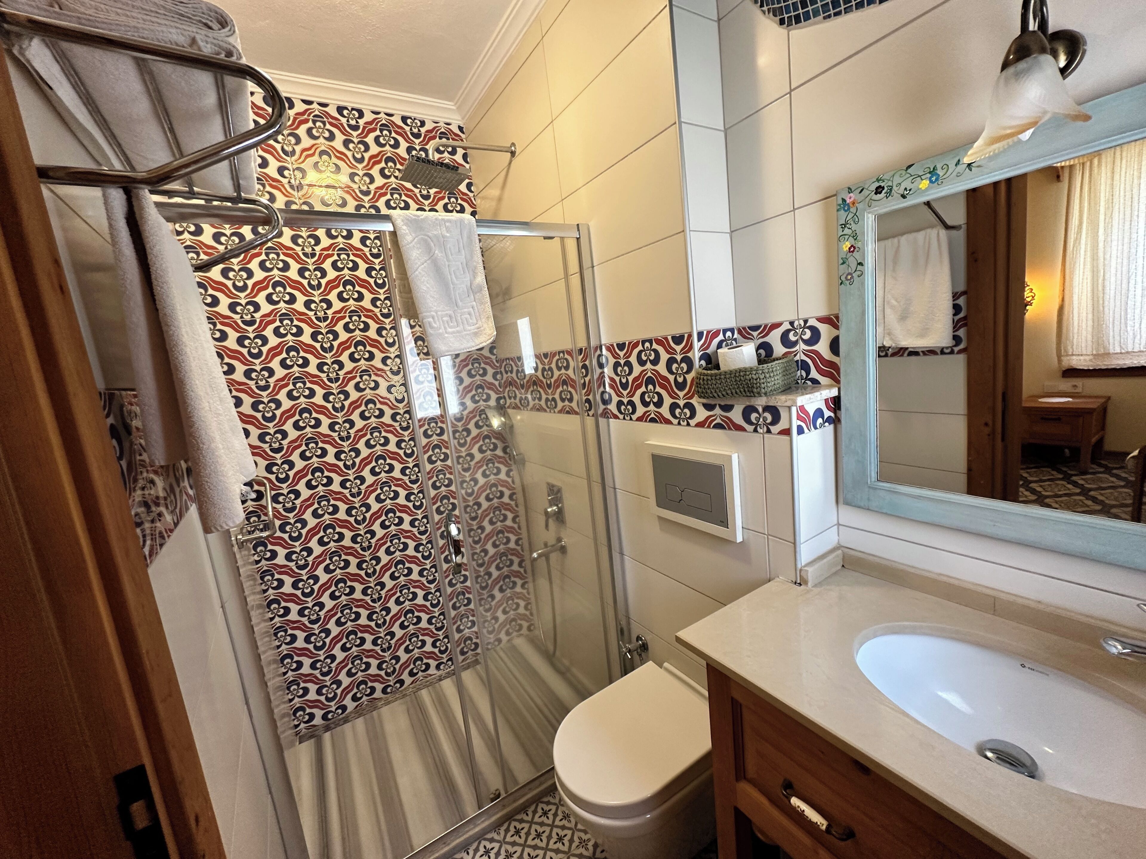 A bathroom with a shower, toilet, and sink.