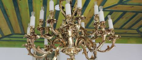 A chandelier with multiple arms and candle-like fixtures.