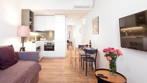 A modern apartment with a kitchen, dining area, and living space.