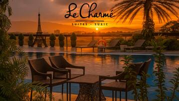 Outdoor pool, open 8:00 AM to 8 PM, pool loungers
