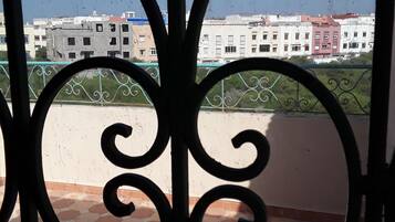 Enjoy the city view from this balcony with a decorative gate and hexagonal tile floor.