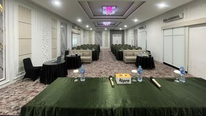 A conference room with a long table, rows of chairs, and a carpeted floor. - Soeltan Luxe Hotel (Bandar Lampung)