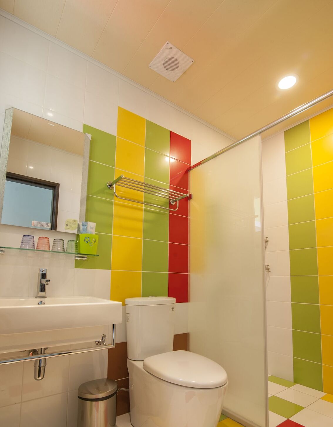 A bathroom with a toilet, sink, and shower.