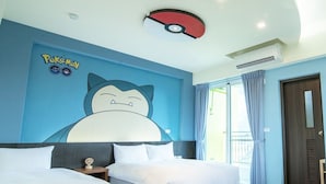 A hotel room with two beds, a large wall mural of a Pokémon character, and a ceiling light fixture. - TT Blue B&B (Taitung)