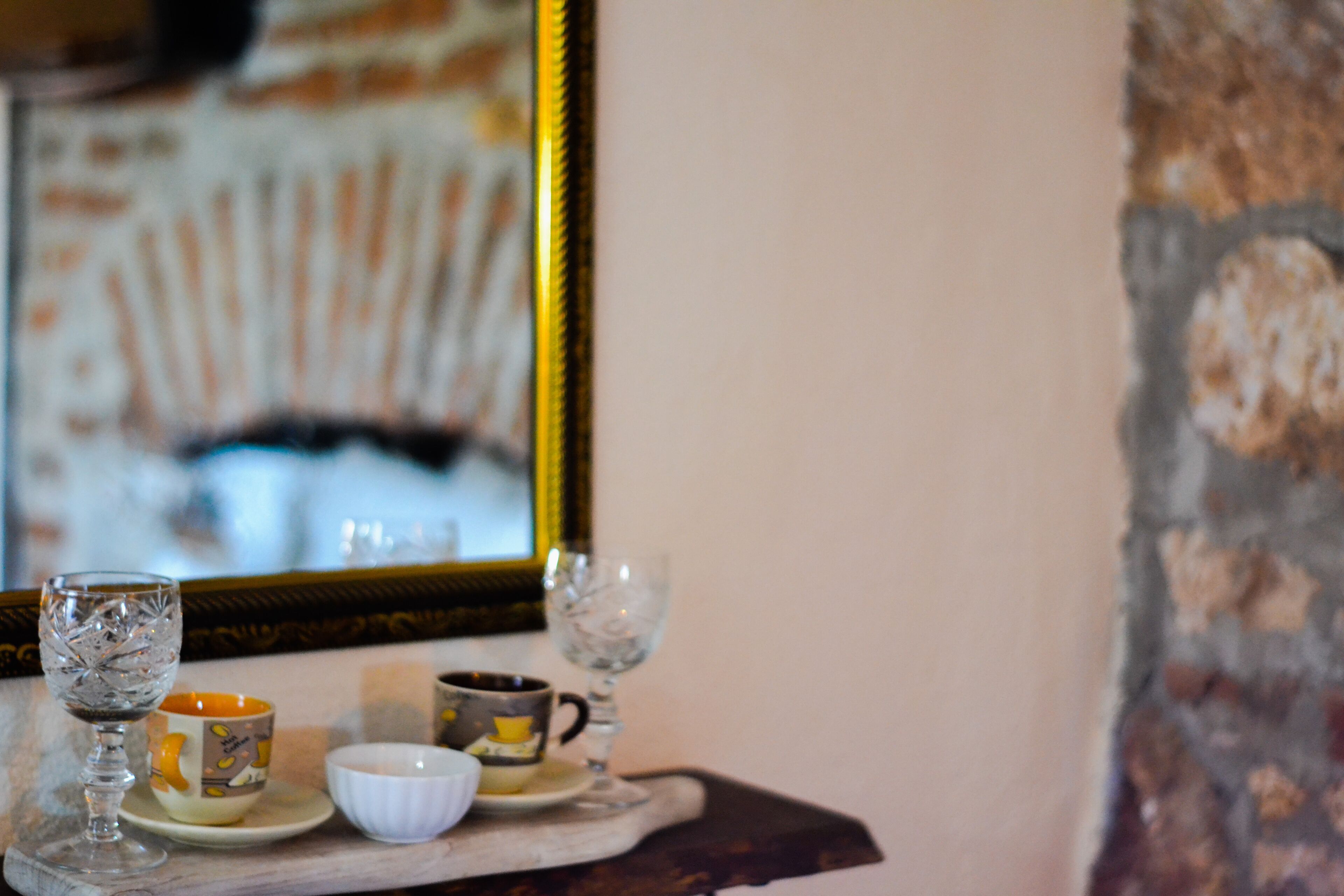 A table with a glass, a mug, and a bowl.