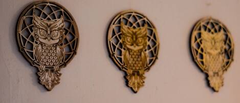Three wooden wall decorations with owl designs.