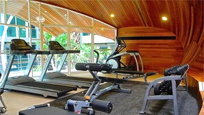 A gym with treadmills, weight machines, and benches. - Emerald Patong 1 bedroom Modern Apartment (Patong)