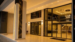 The exterior of the Hotel Kayalar with a modern design, featuring a glass entrance and illuminated signage. - Hotel Kayalar (Antalya)