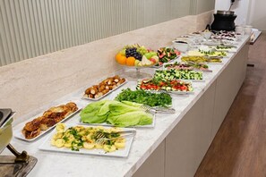A buffet with various food options including fruits, salads, and cooked dishes. - Hotel Kayalar (Antalya)