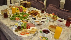 Un buffet della colazione con diversi piatti, bevande e salse.
