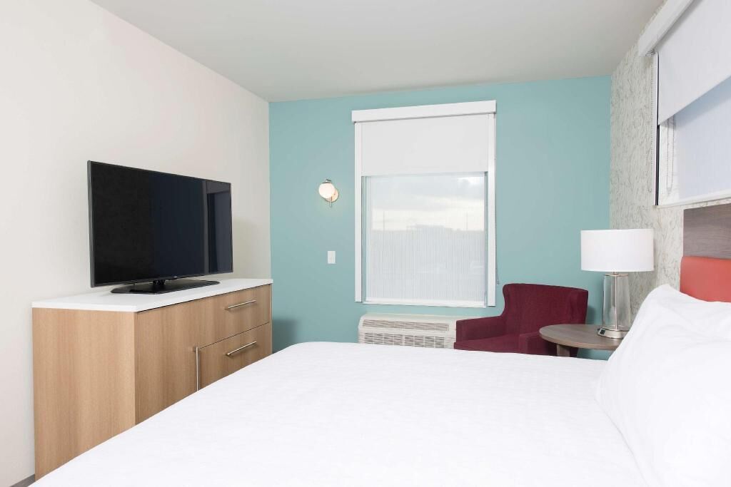 Desk, iron/ironing board, bed sheets