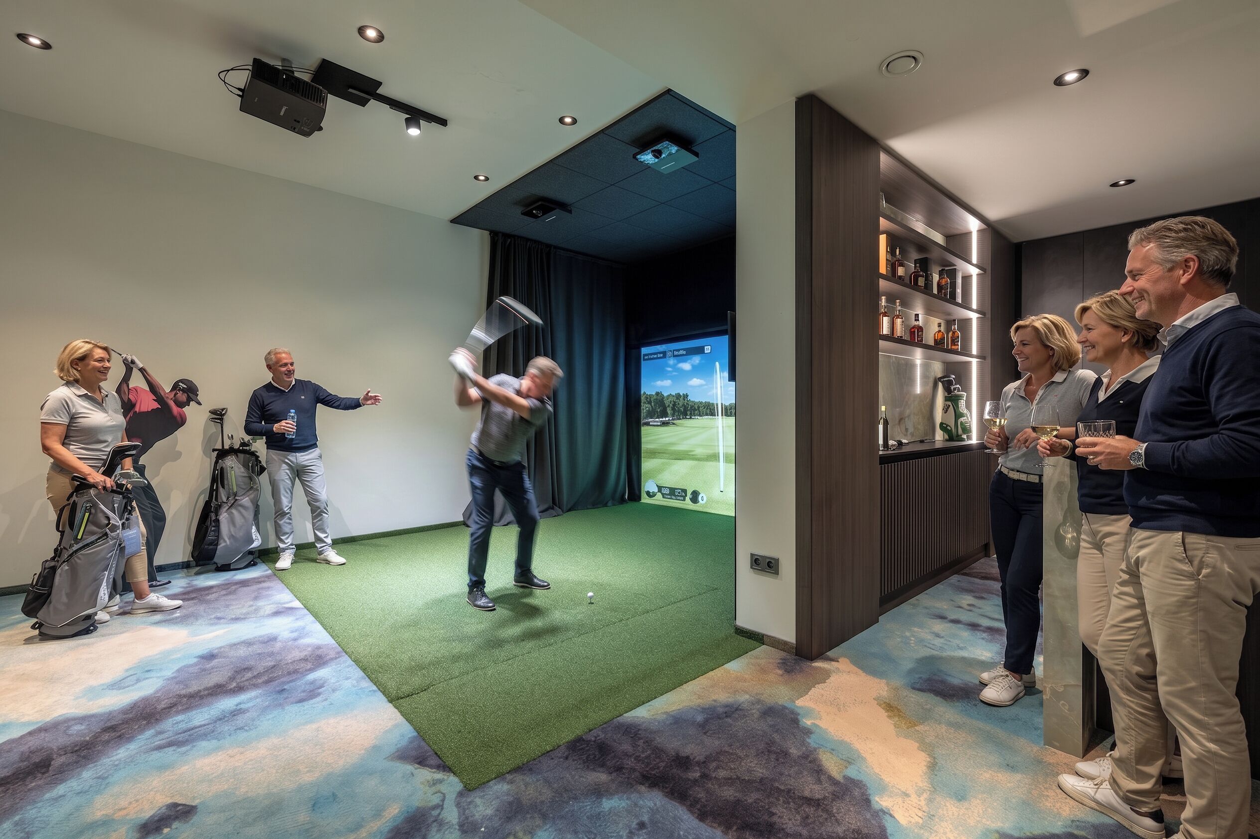 A room with a green carpet, a projector screen, and a bar area with shelves.