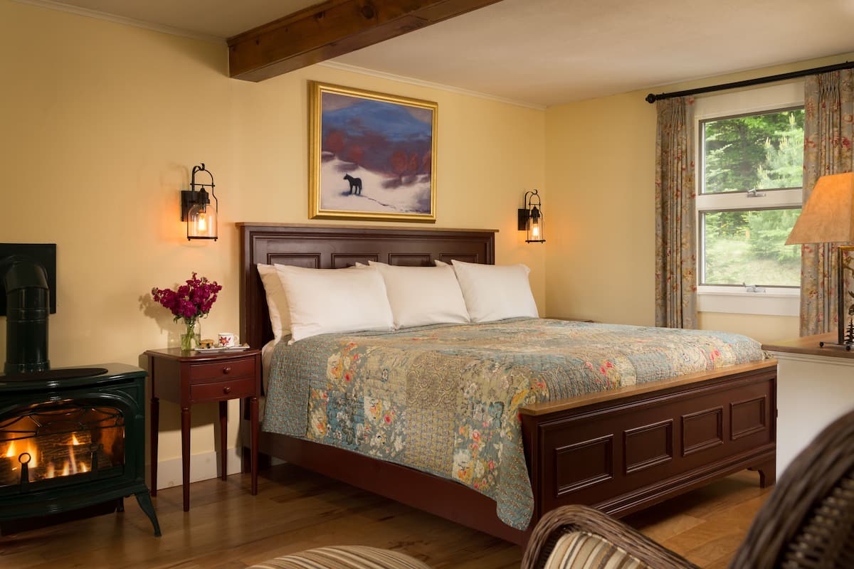 Perennial Fireplace Cottage Room | Premium bedding, individually decorated, individually furnished