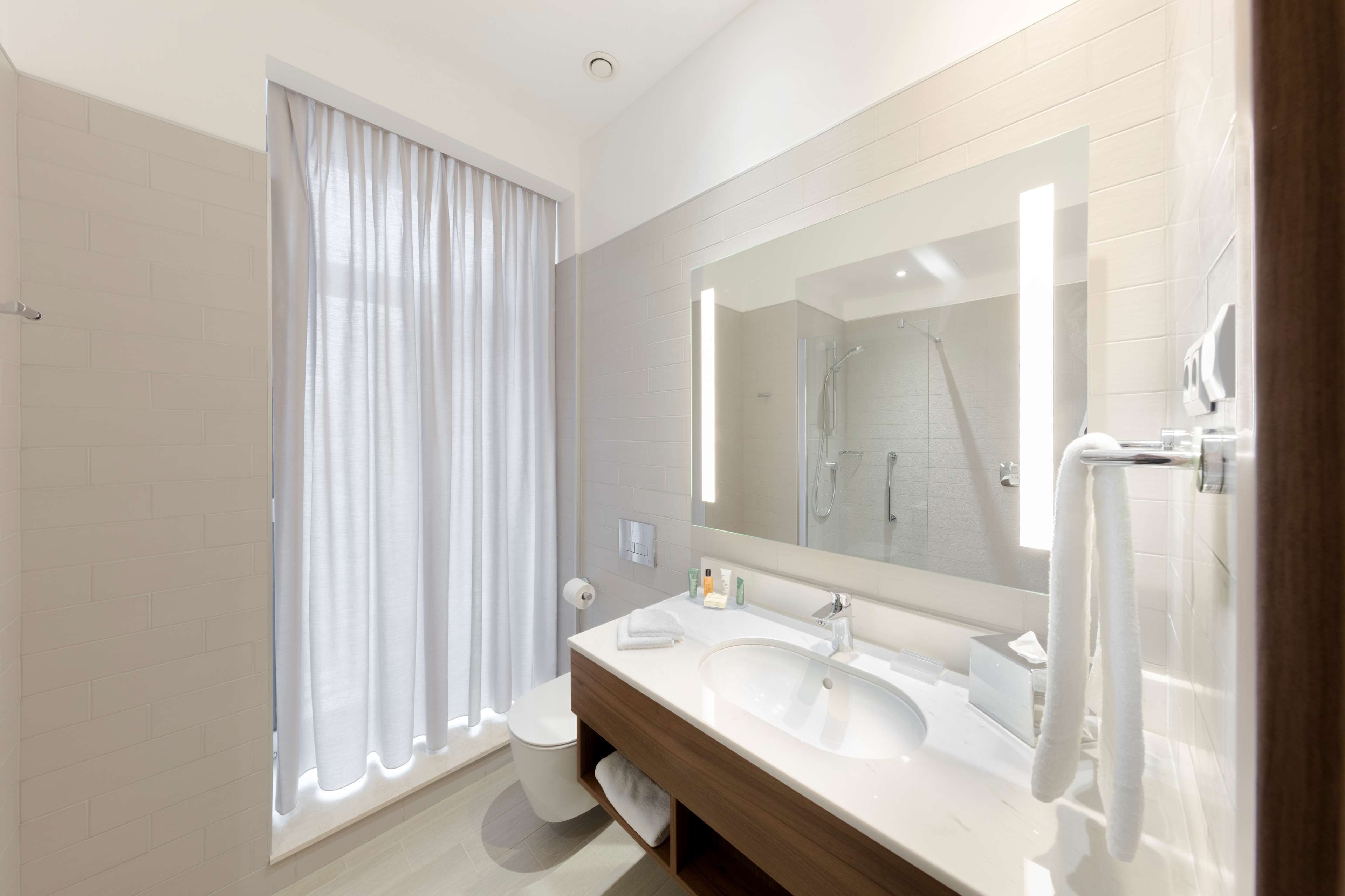 designer toiletries, hair dryer, towels