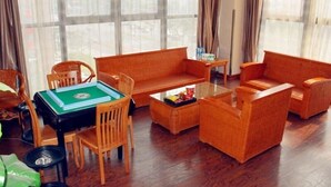 A room with a sofa, chairs, a table, and a green board game. - GreenTree Inn Changzhou Zhongwu Avenue Lihua  Hotel (Changzhou)