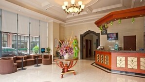 A hotel lobby with a reception desk, seating area, and a large window offering a view of the street. - GreenTree Inn Changzhou Zhongwu Avenue Lihua  Hotel (Changzhou)