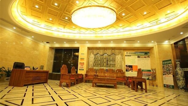 A lobby with a patterned floor, wooden furniture, a reception desk, and a decorative ceiling. - GreenTree Business Inn HuiZhou South Railway Station DanShui RenMin Road Business Hotel (Huizhou)