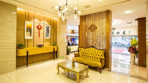 A modern lobby with a reception desk, a sofa, and a coffee table. - GreenTree Inn JieYang Bus Terminal Station RongHua Avenue Hotel (Jieyang)