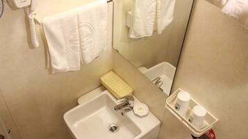 A bathroom with a sink, a mirror, a towel rack, and a hairdryer.