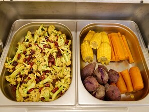 Two stainless steel trays, one with cauliflower and red peppers, the other with corn, carrots, and potatoes. - GreenTree Inn JiangSu XuZhou Pizhou Railway Station Jiefang West Road Business Hotel (Xuzhou)