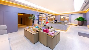 A modern retail space with a central counter, display shelves, and seating areas. - Greentree Inn Site South Yanggao Road Subway Stati (Shanghai)
