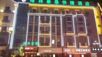 Vista frontal de la propiedad por la tarde o noche