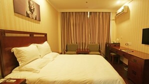 A hotel room with a large bed, a desk, a chair, and a television. - GreenTree Inn Yangquan District Desheng Street Industry and Trade Building Express Hotel (Yangquan)