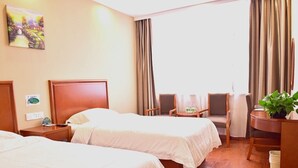 A hotel room with two beds, a desk, a chair, and a small table. - GreenTree Inn BaoDing Xiong county XiongZhou Road Express Hotel (Baoding)