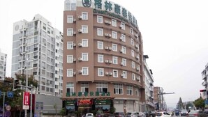 A multi-story hotel with a prominent sign for GreenTree Express. - GreenTree Inn TaiZhou XianJu Passenger Center West HuanCheng Road Express Hotel (Taizhou)