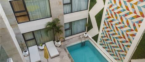 Outdoor pool, open 9:00 AM to 9:00 PM, pool umbrellas, pool loungers